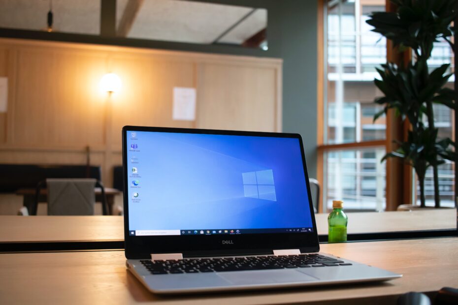 A picture of a laptop computer sitting on a desk showing Microsoft Windows
